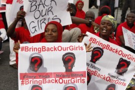 People attend a demonstration calling on the government to rescue the kidnapped girls of the government secondary school in Chibok, in Abuja, Nigeria, Thursday, May 22, 2014. Scores of protesters chanting "Bring Back Our Girls" marched in the Nigerian capital Thursday as many schools across the country closed to protest the abductions of more than 300 schoolgirls by Boko Haram, the government's failure to rescue them and the killings of scores of teachers by Islamic extremists in recent years. (AP Photo/Sunday Alamba)