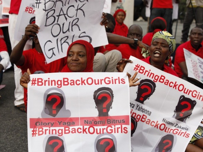 People attend a demonstration calling on the government to rescue the kidnapped girls of the government secondary school in Chibok, in Abuja, Nigeria, Thursday, May 22, 2014. Scores of protesters chanting "Bring Back Our Girls" marched in the Nigerian capital Thursday as many schools across the country closed to protest the abductions of more than 300 schoolgirls by Boko Haram, the government's failure to rescue them and the killings of scores of teachers by Islamic extremists in recent years. (AP Photo/Sunday Alamba)
