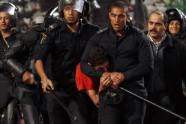 Riot police and security forces detain a fan of Egypt's Al-Ahly, known as "Ultras", during clashes after their African Super Cup soccer match against Tunisia's CS Sfaxien at Cairo Stadium February 20, 2014. Al-Ahly won the African Super Cup title. REUTERS/Amr Abdallah Dalsh (EGYPT - Tags: SPORT SOCCER CIVIL UNREST)