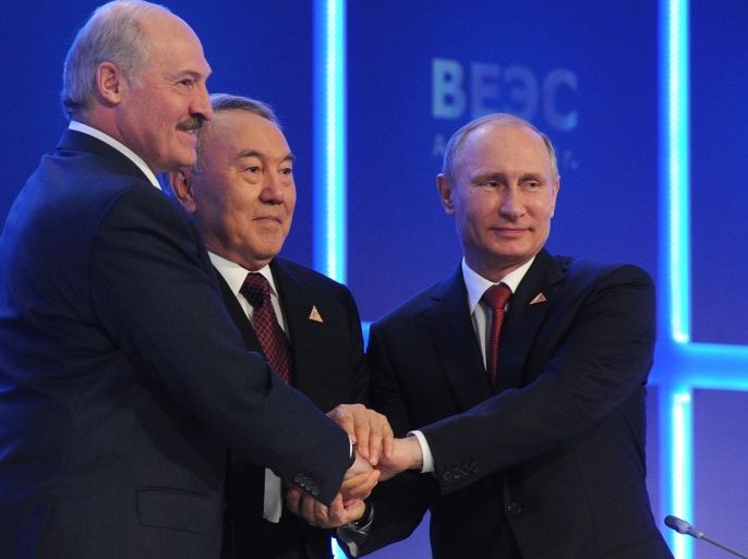 From right, Russian President Vladimir Putin, Kazakh President Nursultan Nazarbayev and Belarusian President, Alexander Lukashenko shake hands after signing an agreement to create the Eurasian Economic Union in Astana, Kazakhstan, Thursday, May 29, 2014. The leaders of Russia, Belarus and Kazakhstan on Thursday created an economic union that intends to boost cooperation between the ex-Soviet neighbors, a pact which was at the source of the crisis in Ukraine. (AP Photo/RIA-Novosti, Mikhail Klimentyev, Presidential Press Service)