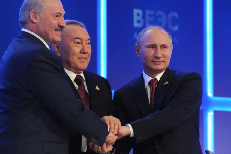 From right, Russian President Vladimir Putin, Kazakh President Nursultan Nazarbayev and Belarusian President, Alexander Lukashenko shake hands after signing an agreement to create the Eurasian Economic Union in Astana, Kazakhstan, Thursday, May 29, 2014. The leaders of Russia, Belarus and Kazakhstan on Thursday created an economic union that intends to boost cooperation between the ex-Soviet neighbors, a pact which was at the source of the crisis in Ukraine. (AP Photo/RIA-Novosti, Mikhail Klimentyev, Presidential Press Service)