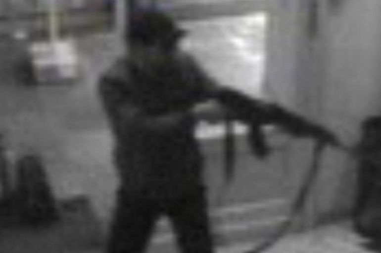 In this hand out photo distributed on Sunday, May 25, 2014 by the Belgian Federal Police, a surveillance camera shows a man shooting at the Jewish museum in Brussels, Belgium, on Saturday, May 24, 2014. Police stepped up security at Jewish institutions, schools and synagogues after three people were killed and one seriously injured in a spree of gunfire at the Jewish Museum in Brussels on Saturday. (AP Photo/Belgian Federal Police)
