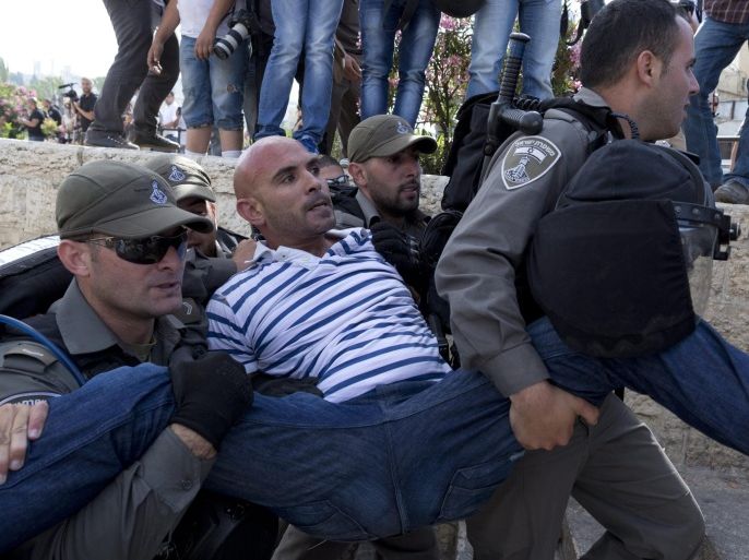A Palestinian man who refused to move on is carried away under arrest by Israeli Border Police during clashes on Jerusalem Day, 28 May 2014, at the damascus Gate in East Jerusalem. Clashes broke out when Palestinians protested with their flag before thousands of right-wing Israelis marched through Jerusalem and the Old City to the Western Wall in a show of strength and support for the 'unification' of Jerusalem during the Six Day War in June 1967. Palestinians and much of the world do not accept Israel's annexation of East Jerusalem after the war, and consider it 'occupied territory.'