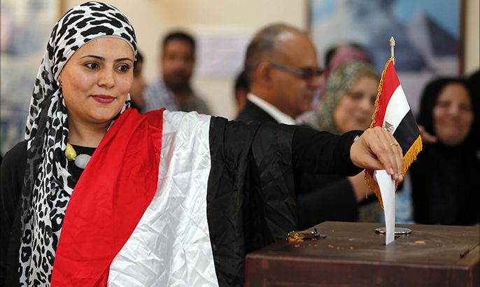 An Egyptian expatriate living in Oman casts her ballot for Egypt's upcoming May 26-27 presidential elections at the Egyptian embassy in Muscat on May 16, 2014. Egyptian expatriates around the world headed to the polls, casting the first votes