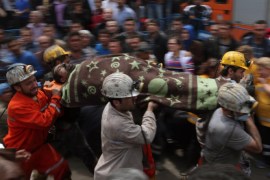 Rescue workers carry the dead body of a miner outside the coal mine in Soma, Turkey, Wednesday, May 14, 2014. An explosion and fire at the coal mine killed at least 232 workers, authorities said, in one of the worst mining disasters in Turkish history. Turkey's Energy Minister Taner Yildiz said 787 people were inside the coal mine at the time of the accident. (AP Photo/Emrah Gurel)