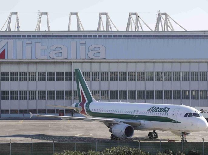 An Alitalia plane is parked on the tarmac at Fiumicino international airport in Rome December 10, 2013. REUTERS/Max Rossi