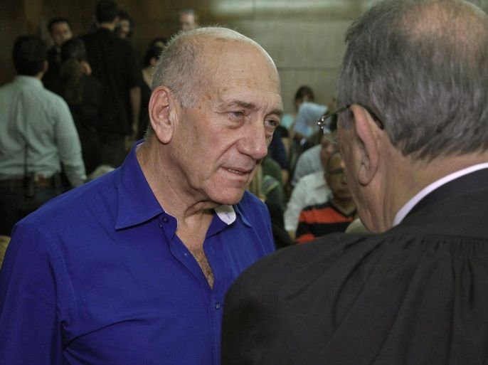 Former Israeli Prime Minister Ehud Olmert (L) speaks to one of his lawyers upon his arrival at the Tel Aviv District Court, in Tel Aviv, Israel, 13 May 2014. An Israeli court on 13 May sentenced former prime minister Ehud Olmert to six years in prison, six weeks after convicting him on two counts of bribe-taking when he served as mayor of Jerusalem. He was also handed a fine of some 600,000 dollars. Olmert, 68, has become the first former premier in Israel to have been indicted, convicted, and sent to jail.