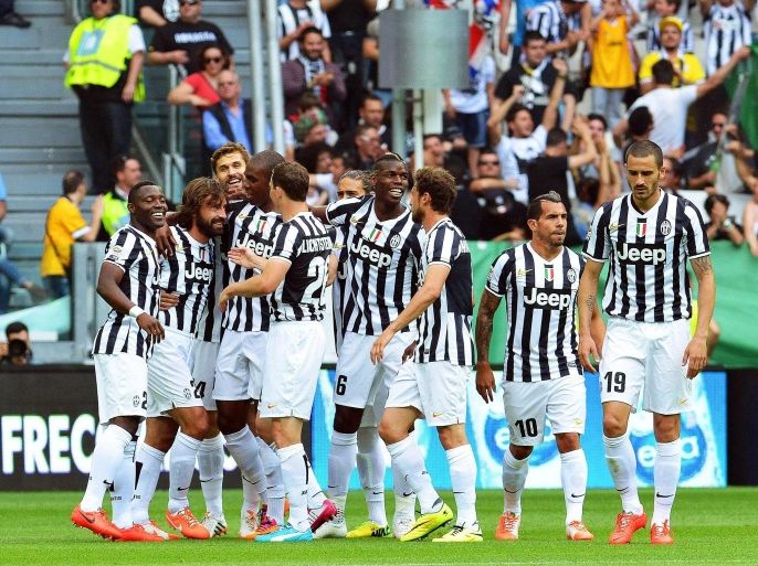 Juventus' Andrea Pirlo (2-L) celebrates with his teammates after scoring the opening goal during the Italian Serie A soccer match between Juventus FC and Cagliari Calcio at the Juventus Stadium in Turin, Italy, 18 May 2014.
