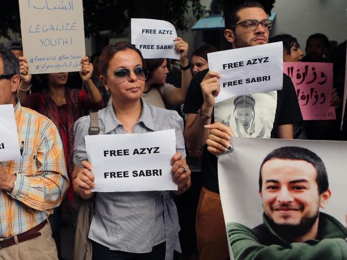 Tunisian protesters hold a poster depicting Azyz Amami during a protest to put pressure on the authorities to release activist Azyz Amami and photographer Sabri Ben Mlouka the day of their trial on the outside of the courthouse in Tunis, Tunisia, 23 May 2014. Azyz Amami and Sabri Ben Mlouka were arrested on the night of 12 May in La Goulette, a suburb of Tunis. They are charged with possession and use of cannabis. Law No. 52 of 1992 on narcotics provides a penalty of imprisonment from one to five years to 'any consumer or owner to use personal consumption of narcotic substances or plants'. Since the arrest of Azyz Amami, known for his activism during the revolution, several political voices have been raised against this 'Act 52'.