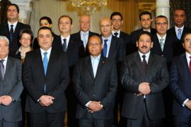 tunisian president moncef marzouki (c) and a new prime minister mehdi jomaa(2nd l) pose for a group picture with the ministers of the new government at the carthage presidential palace on the outskirts of tunis on january 29, 2014. tunisia's parliament approved a technocratic caretaker government tasked with leading the country out of a bruising political crisis and into fresh elections. afp