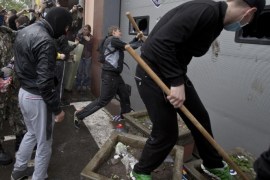 Pro-Russian protesters break the vehicle access gate at a police station building in Odessa, Ukraine, Sunday, May 4, 2014. Several prisoners that were detained during clashes that erupted Friday between pro-Russians and government supporters in the key port on the Black Sea coast were released under the pressure of protesters that broke into a local police station and received a hero's welcome by crowds. (AP Photo/Vadim Ghirda)