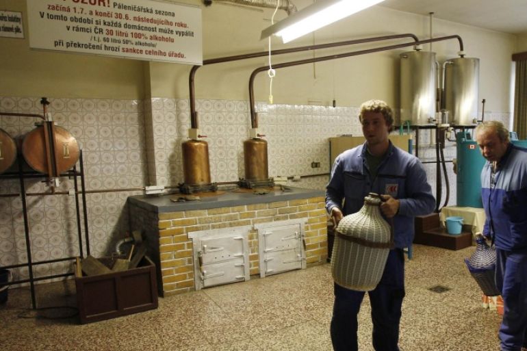 In this photo taken in Breznice, village in eastern Czech Republic, Thursday, Sept. 20, 2012, customers carry out their liquor made at a private distillery. Czech people continue their centuries-old tradition of home distilled spirits that remains the only option to legally obtain hard liquors after sales and exports were banned following a wave of methanol poisoning that has killed at least 23 people.