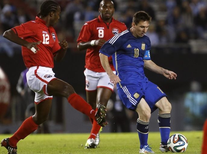 Argentina's Lionel Messi, right, runs with the ball followed by Trinidad and Tobago's Yohance Marshall, left, during their international friendly soccer match in Buenos Aires, Argentina, Wednesday, June 4, 2014. (AP Photo/Victor R. Caivano)