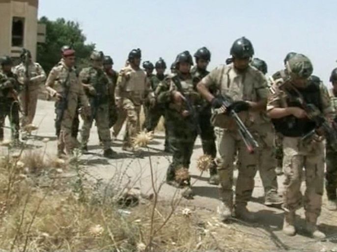 In this Monday, June 9, 2014 image taken from video obtained from the Iraqi Military, which has been authenticated based on its contents and other AP reporting, military soldiers prepare to take their positions during clashes with militants in the northern city of Mosul, Iraq. Insurgents on Tuesday pressed their efforts to seize effective control of Iraq’s second-largest city of Mosul on Tuesday after Iraqi security forces abandoned their posts and militants overran the provincial government headquarters and other key buildings, dealing a serious blow to Baghdad’s attempts to tame a widening insurgency in the country. (AP Photo/Iraqi Military via AP video)