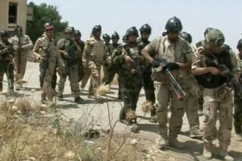 In this Monday, June 9, 2014 image taken from video obtained from the Iraqi Military, which has been authenticated based on its contents and other AP reporting, military soldiers prepare to take their positions during clashes with militants in the northern city of Mosul, Iraq. Insurgents on Tuesday pressed their efforts to seize effective control of Iraq’s second-largest city of Mosul on Tuesday after Iraqi security forces abandoned their posts and militants overran the provincial government headquarters and other key buildings, dealing a serious blow to Baghdad’s attempts to tame a widening insurgency in the country. (AP Photo/Iraqi Military via AP video)