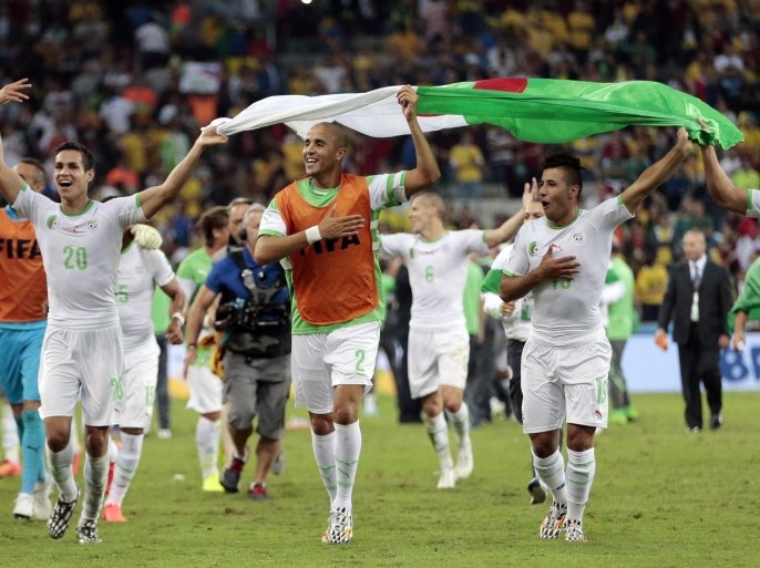 Algerian players celebrate after the group H World Cup soccer match between Algeria and Russia at the Arena da Baixada in Curitiba, Brazil, Thursday, June 26, 2014. The match ended in a 1-1 draw, but Algeria qualified for the round of 16. (AP Photo/Ivan Sekretarev)