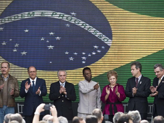 Brazilian football legend Edson Arantes do Nascimento (C), known as Pele, attends the inauguration of the Pele Museum, in Santos, some 70 km from Sao Paulo, Brazil, on June 15, 2014. The Pele Museum was built in an area of 4,134 square-metre at a cost of 20 million US dollars and has a collection of 2,545 pieces of one of the world's biggest football idols. AFP PHOTO / NELSON ALMEIDA