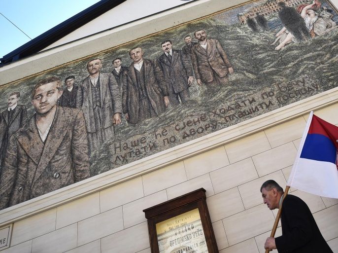A man walks past a mural depicting Gavrilo Princip, the man who killed Austrian Archduke Franz Ferdinand one hundred years ago, and other members of 'Mlada Bosna' movement in the Bosnian Serb-run town of Visegrad, on June 28, 2014. Sarajevo on Saturday marks 100 years since the assassination that triggered World War I, plunging Europe into the bloodiest conflict it had ever seen and redrawing the world map. With the people of the Balkans still deeply divided over the legacy of that fateful day, separate commemorations were to be held to mark the occasion. AFP PHOTO / ANDREJ ISAKOVIC