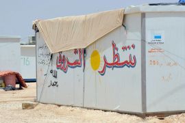 ننتظر الشروق عبارة خطها لاجيء سوري على بيت الصفيح الذي يقطنه في مخيم الزعتري للاجئين السوريين.