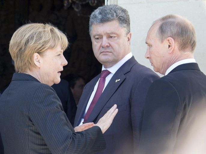 BENOUVILLE, FRANCE - JUNE 06: (L-R) German Chancellor Angela Merkel, Petro Poroshenko and Russian President Vladimir Putin are seen after their lunch on June 6, 2014 in Benouville, France. Friday 6th June is the 70th anniversary of the D-Day landings which saw 156,000 troops from the allied countries including the United Kingdom and the United States join forces to launch an audacious attack on the beaches of Normandy, these assaults are credited with the eventual defeat of Nazi Germany. A series of events commemorating the 70th anniversary are planned for the week with many heads of state travelling to the famous beaches to pay their respects to those who lost their lives.