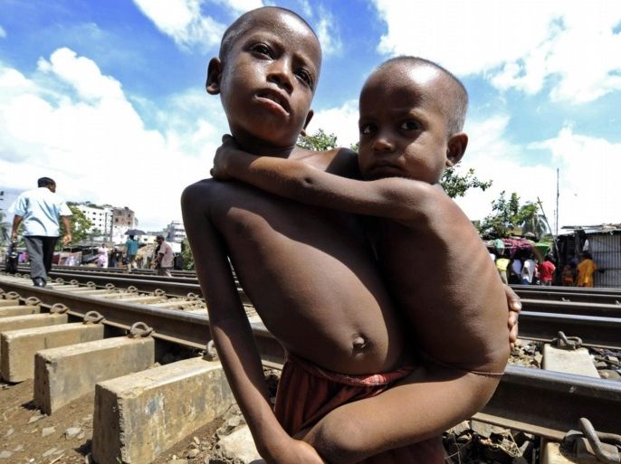 A malnourished Bangladeshi boy, Kader holds his younger brother near their rail road side home in Dhaka on July 31, 2008. Malnutrition in children, adolescents and women is a major concern. Despite progress, levels of malnutrition in Bangladesh are amongst the highest in the world, and this is a major cause of death and disease in children and women.