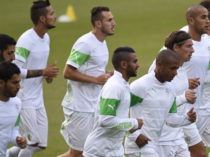 Algeria's players run during a training session at the Antonio Couto Pereira stadium in Curitiba on June 25, 2014, on the eve of a group H football match against Russia during the 2014 FIFA World Cup. AFP PHOTO/ PHILIPPE DESMAZES