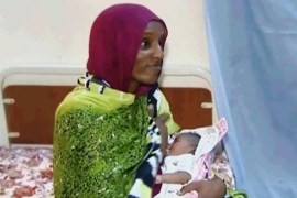 FILE - In this file image made from an undated video provided Thursday, June 5, 2014, by Al Fajer, a Sudanese nongovernmental organization, Meriam Ibrahim breastfeeds her newborn baby girl that she gave birth to in jail last week, as the NGO visits her in a room at a prison in Khartoum, Sudan. Sudan's official news agency, SUNA, said the Court of Cassation in Khartoum on Monday, June 23, canceled the death sentence against 27-year-old Meriam Ibrahim after defense lawyers presented their case. The court ordered her release. (AP Photo/Al Fajer, File)