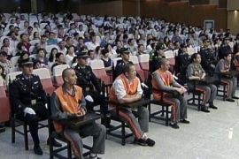 In this Tuesday, June 16, 2014 image taken from video, defendants sit in a court in the Xinjiang regional capital of Urumqi, China. The court sentenced three people to death Monday for planning a deadly car ramming at Beijing's iconic Tiananmen Gate last year that was blamed on Muslim separatists, state media reported. (AP Photo/CCTV via AP Video) CHINA OUT, NO SALES, NO ARCHIVES, EDITORIAL USE ONLY