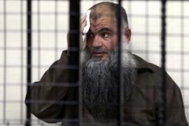 Radical Islamist cleric Omar Mahmoud Othman, Abu Qatada, looks from behind bars during his trial at Jordan's State Security Court in Amman, Jordan, 26 June 2014. A Jordanian court on 26 June acquitted the radical cleric Abu Qatada of conspiring to commit acts of terrorism in the 1990s. He was accused of involvement in a plot to carry out a series of attacks against Western diplomats and government targets in Amman. He will remain in jail on separate charges of planning to attack tourists in Jordan at the turn of the century, known as the Millennium Bombings plot.