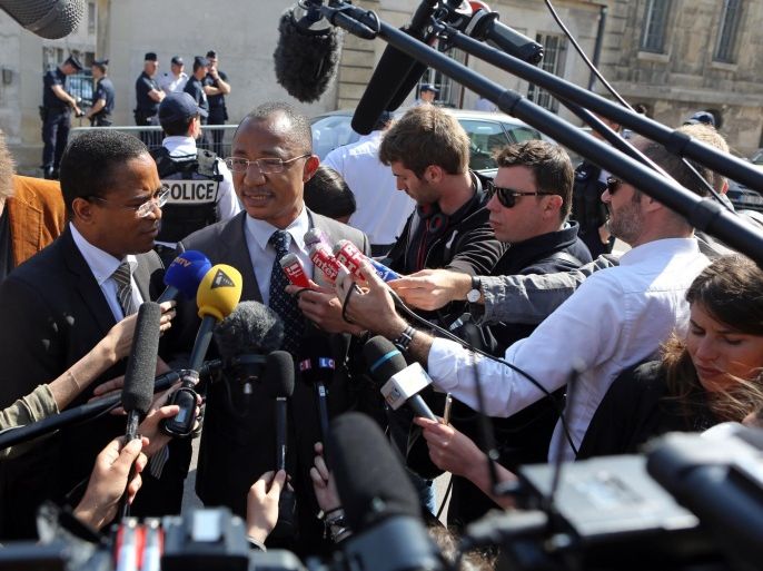 Apolin Pepiezep, center, the lawyer of Mehdi Nemmouche addresses reporters outside Versailles Court of Appeal, West of Paris, Thursday, June 12, 2014. Medhi Nemmouche is the Frenchman suspected in the shooting deaths of three people at the Brussels Jewish Museum. The court will take his decision on June 26, wether or not to extradite Mehdi Nemmouche to Belgium.(AP Photo/Remy de la Mauviniere)