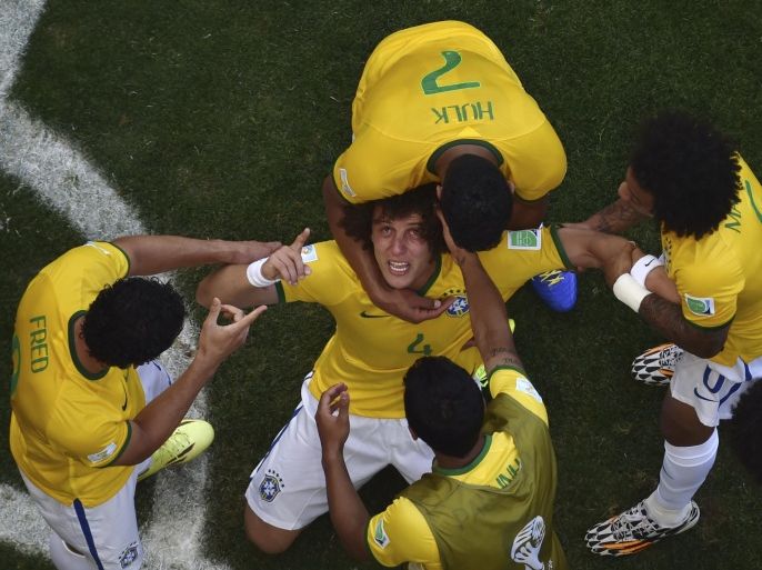 Brazil's David Luiz is surrounded by teammates after Brazil's first goal during the World Cup round of 16 soccer match between Brazil and Chile at the Mineirao Stadium in Belo Horizonte, Brazil, Saturday, June 28, 2014. (AP Photo/Francois Xavier Marit, pool)