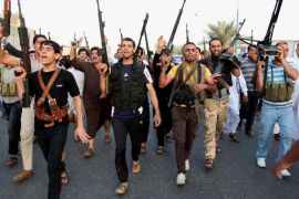 Iraqi Shiite tribal fighters deploy with their weapons while chanting slogans against the al-Qaida inspired Islamic State of Iraq and the Levant (ISIL), to help the military, which defends the capital in Baghdad's Sadr City, Iraq, Friday, June 13, 2014. The tribal leaders met in Sadr city on Friday and declared their readiness along with their tribesmen to take up arms against the al-Qaida inspired group that has made advances in Iraq's Sunni heartland .(AP Photo/ Karim Kadim)