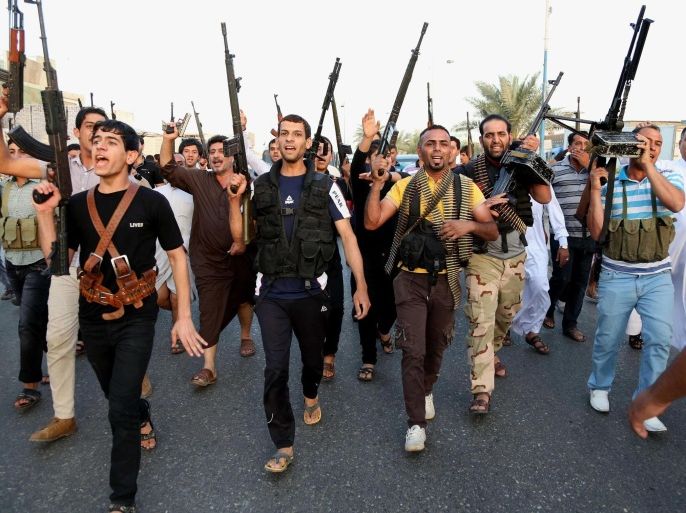 Iraqi Shiite tribal fighters deploy with their weapons while chanting slogans against the al-Qaida inspired Islamic State of Iraq and the Levant (ISIL), to help the military, which defends the capital in Baghdad's Sadr City, Iraq, Friday, June 13, 2014. The tribal leaders met in Sadr city on Friday and declared their readiness along with their tribesmen to take up arms against the al-Qaida inspired group that has made advances in Iraq's Sunni heartland .(AP Photo/ Karim Kadim)