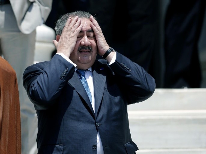 Iraqi Foreign Minister Hoshyar Zebari reacts to the heat before a group photo during an EU-Arab league Foreign Ministers summit in Athens, on Wednesday, June 11, 2014. The fall of the major northern Iraqi city of Mosul to insurgents must push the country's leaders to work together and deal with the "mortal threat" facing Iraq, the country's foreign minister said Wednesday.(AP Photo/Petros Giannakouris)