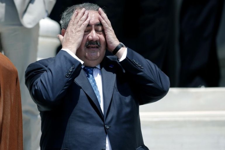 Iraqi Foreign Minister Hoshyar Zebari reacts to the heat before a group photo during an EU-Arab league Foreign Ministers summit in Athens, on Wednesday, June 11, 2014. The fall of the major northern Iraqi city of Mosul to insurgents must push the country's leaders to work together and deal with the "mortal threat" facing Iraq, the country's foreign minister said Wednesday.(AP Photo/Petros Giannakouris)