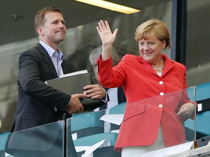 German President Angela Merkel waves after watching the group G World Cup soccer match between Germany and Portugal at the Arena Fonte Nova in Salvador, Brazil, Monday, June 16, 2014. Germany won 4-0. (AP Photo/Matthias Schrader)