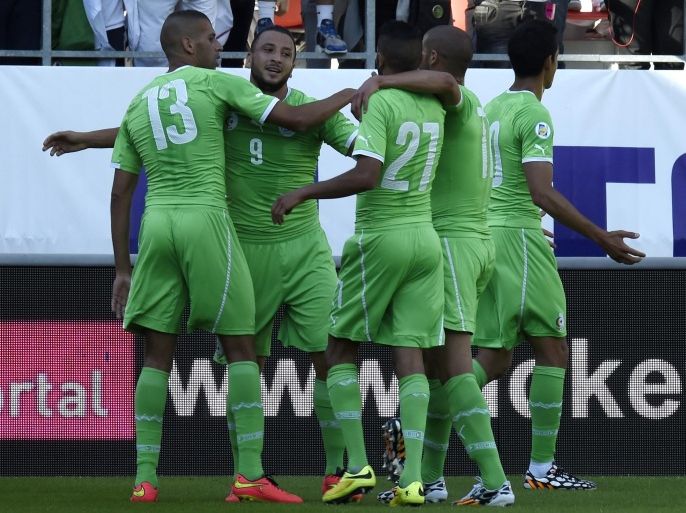 Algeria's forward Nabil Ghilas (2ndL) is congratuled by teammates after scoring during the friendly football match between Algeria and Armenia, at the Tourbillon stadium in Sion, on May 31, 2014. AFP PHOTO/PHILIPPE DESMAZES