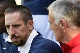 France's national football team midfielder Franck Ribery (L) looks on next to France's head coach Didier Deschamps before a team group photo at the French national football team's training base in Clairefontaine-en-Yvelines, outside Paris, on June 6, 2014, during France's national football team's preparation for the upcoming FIFA 2014 World Cup in Brazil. Deschamps confirmed today that 31-year-old Ribery failed to recover from a nagging back injury, ruling him out of the World Cup. Deschamps also announced that midfielder Clement Grenier would also miss the World Cup because of a thigh injury he suffered in the 1-1 draw with Paraguay on June 1, 2014. AFP PHOTO / FRANCK FIFE