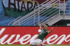 Mexico's Oribe Peralta celebrates after scoring the opening goal during the group A World Cup soccer match between Mexico and Cameroon in the Arena das Dunas in Natal, Brazil, Friday, June 13, 2014. (AP Photo/Ricardo Mazalan)