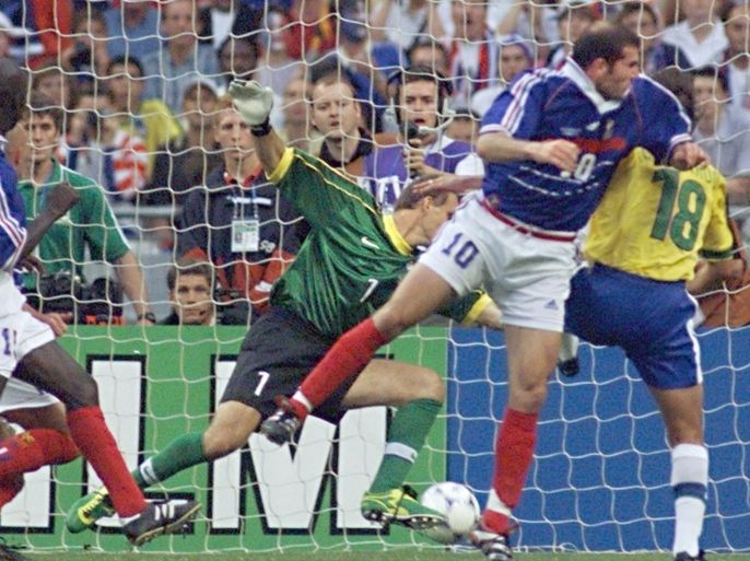 GOAL - French Zinedine Zidane (#10) scores the first goal for his team past Brazilian Leonardo (18) as teammate Lilian Thuram (L) and Brazilian goalkeeper Taffarel (#1) looks on 12 July at the Stade de France in Saint-Denis, near Paris, during the 1998 Soccer World Cup final match between Brazil and France.