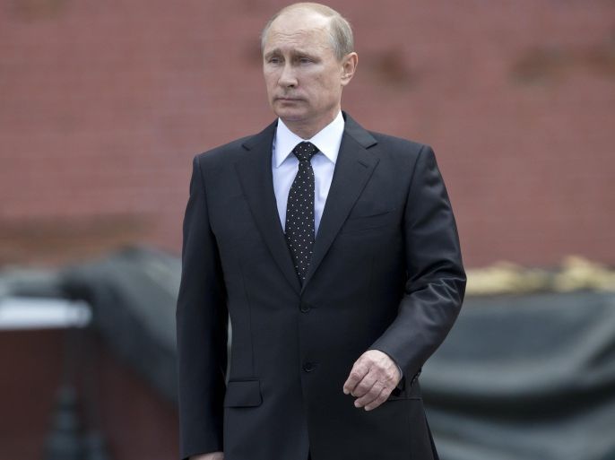 In this photo taken on Sunday, June 22, 2014, Russian Vladimir Putin takes part in a wreath laying ceremony at the Tomb of the Unknown Soldier outside Moscow's Kremlin Wall, in Moscow, Russia, to mark the 73rd anniversary of the Nazi invasion of the Soviet Union. Russian news agencies say President Vladimir Putin has asked parliament to cancel a resolution that sanctions the use of military force in Ukraine. Putin wrote to the head of parliament's upper house asking that a March 1 request authorizing the use of force in neighboring Ukraine be withdrawn. (AP Photo/Alexander Zemlianichenko)