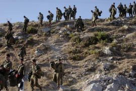 Israeli soldiers search for three missing teens in the town of Halhul near the West Bank city of Hebron, Tuesday, June 24, 2014. Since launching the operation, Israel has detained at least 360 Palestinians, including 250 Hamas operatives and 57 former prisoners released in 2011. The army said it has also raided 63 Hamas civilian institutions. The arrests took place weeks before the alleged kidnapping of the Israeli youths. Since the abduction on June 12, Israel has rounded up dozens of other Hamas operatives freed in the 2011 prisoner swap. The teens have not been heard from and no demands have emerged from their captors. (AP Photo/Majdi Mohammed)