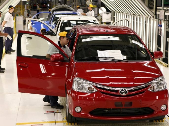 Employees attend a training session at the assembly line of compact car ETIOS at the new plant of Japanese automaker Toyota Motor Corporation in Sorocaba, 100km (62 miles) west of Sao Paulo, in this August 9, 2012 file photo. Growth in Brazil's car market has screeched to a halt, but it is way too late for automakers to hit the brakes. While domestic sales retreat and exports plunge, Brazilian factories are adding over a million vehicles of new capacity in just a few years, racing toward a competitive crunch in the world's fourth biggest auto market. To match Analysis BRAZIL-AUTOS/ REUTERS/Paulo Whitaker (BRAZIL - Tags: TRANSPORT BUSINESS)