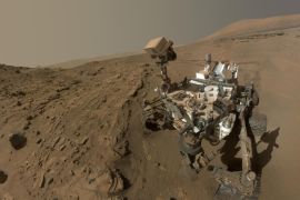 In this image released on June 23, 2014, shows NASA's Curiosity Mars rover self-portrait. NASA's Curiosity Mars used the camera at the end of its arm in April and May 2014 to take dozens of component images combined into this self-portrait where the rover drilled into a sandstone target called "Windjana." NASA’s Mars Curiosity rover will complete a Martian year, 687 Earth days, on June 24. (AP Photo/NASA/JPL-Caltech/MSSS)