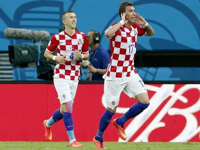 Mario Mandzukic of Croatia (R) celebrates after scoring the 3-0 with Ivan Perisic of Croatia during the FIFA World Cup 2014 group A preliminary round match between Cameroon and Croatia at the Arena Amazonia in Manaus, Brazil, 18 June 2014. (RESTRICTIONS APPLY: Editorial Use Only, not used in association with any commercial entity - Images must not be used in any form of alert service or push service of any kind including via mobile alert services, downloads to mobile devices or MMS messaging - Images must appear as still images and must not emulate match action video footage - No alteration is made to, and no text or image is superimposed over, any published image which: (a) intentionally obscures or removes a sponsor identification image; or (b) adds or overlays the commercial identification of any third party which is not officially associated with the FIFA World Cup) EPA/JEON HEON-KYUN