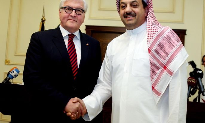 German Foreign Minister Frank-Walter Steinmeier, left, shakes hands with Qatar's Foreign Minister Khaled al-Attiyah for a photo opportunity, during a joint press conference in Doha, Qatar, Sunday, June 1, 2014. (AP Photo/Osama Faisal)