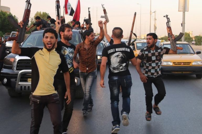 Shiite tribal fighters raise their weapons and chant slogans against the al-Qaida-inspired Islamic State of Iraq and the Levant (ISIL) in Basra, Iraq's second-largest city, 340 miles (550 kilometers) southeast of Baghdad, Iraq, Sunday, June 15, 2014. Emboldened by a call to arms by the top Shiite cleric, Iranian-backed militias have moved quickly to the center of Iraq's political landscape, spearheading what its Shiite majority sees as a fight for survival against Sunni militants who control of large swaths of territory north of Baghdad. (AP Photo/ Nabil Al-Jurani)