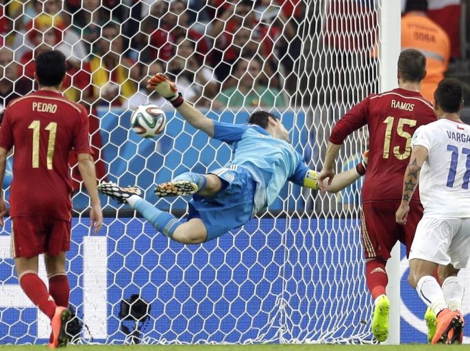 Spain's goalkeeper Iker Casillas can't stop a shot by Chile's Charles Aranguiz allowing Chile to score their side's second goal during the group B World Cup soccer match between Spain and Chile at the Maracana Stadium in Rio de Janeiro, Brazil, Wednesday, June 18, 2014. (AP Photo/Natacha Pisarenko)