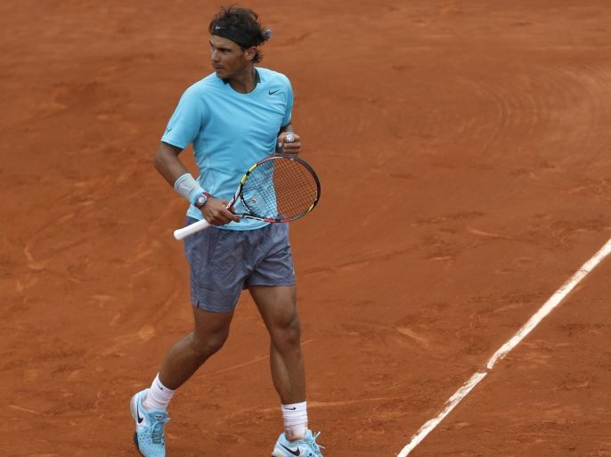 Spain's Rafael Nadal reacts as he defeats Serbia's Dusan Lajovic during their fourth round match of the French Open tennis tournament at the Roland Garros stadium, in Paris, France, Monday, June 2, 2014. Nadal won 6-1, 6-2, 6-1. (AP Photo/Darko Vojinovic)