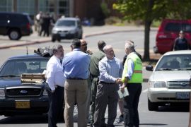 Officials work at the scene of a shooting at Reynolds High School Tuesday, June 10, 2014, in Troutdale, Ore. A teen gunman armed with a rifle shot and killed a student Tuesday and injured a teacher at the high school in a quiet Columbia River town in Oregon then likely killed himself, authorities said. (AP Photo/The Oregonian, Beth Nakamura) MAGS OUT; TV OUT; LOCAL TV OUT; LOCAL INTERNET OUT; THE MERCURY OUT; WILLAMETTE WEEK OUT; PAMPLIN MEDIA GROUP OUT